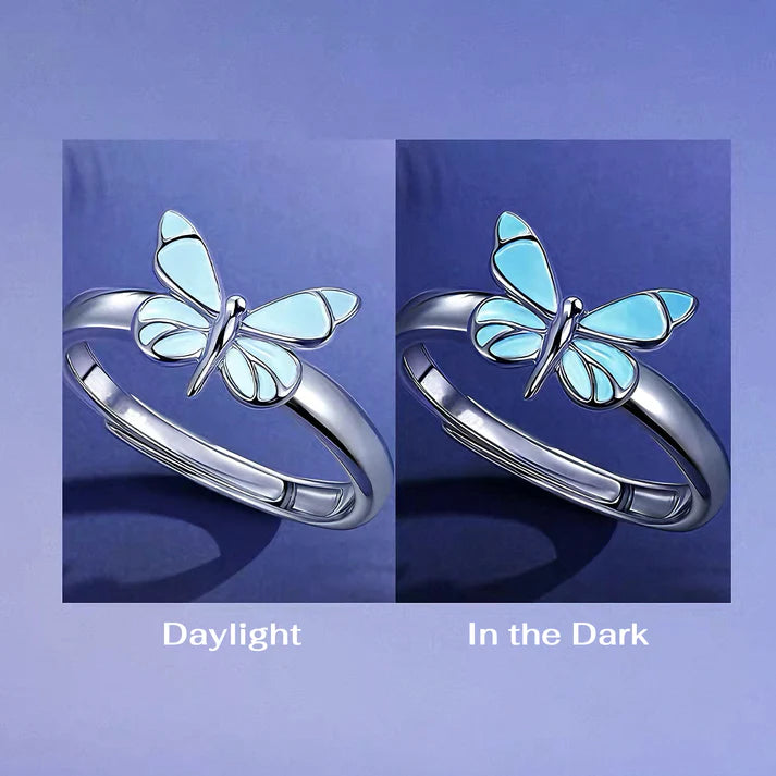 Butterfly-shaped ring with daylight and dark lighting comparison on a blue background