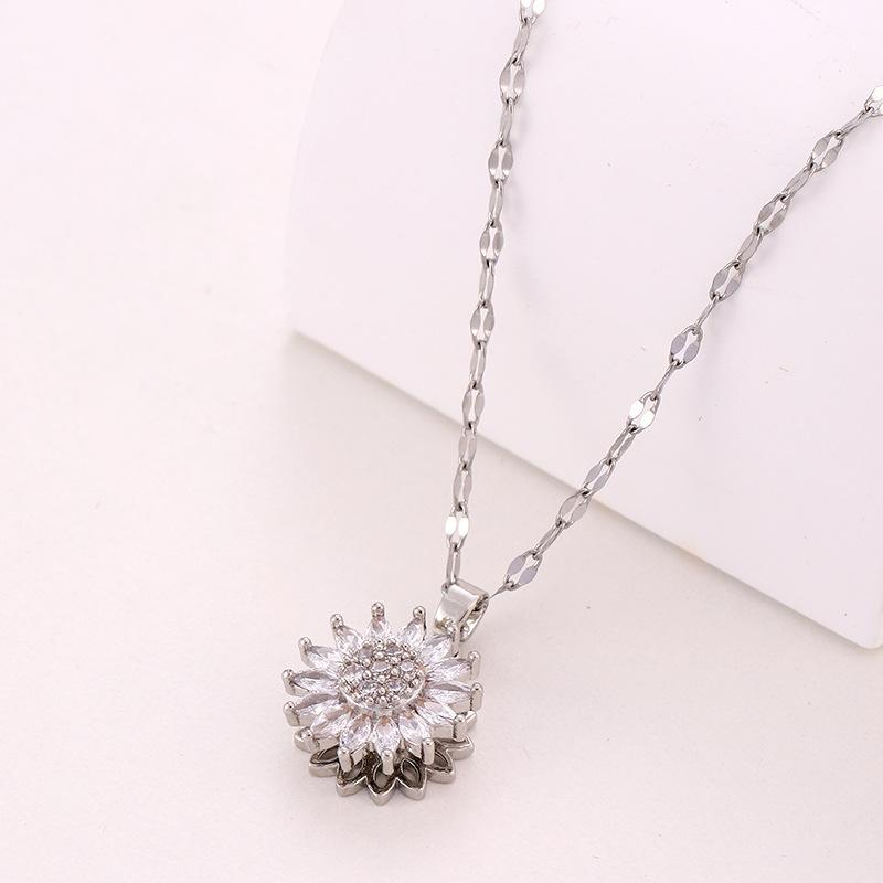Silver necklace with a diamond pendant on a white background