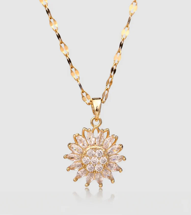 Gold necklace with a star-shaped pendant on a light gray background