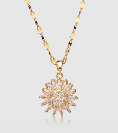 Gold necklace with a star-shaped pendant on a light gray background